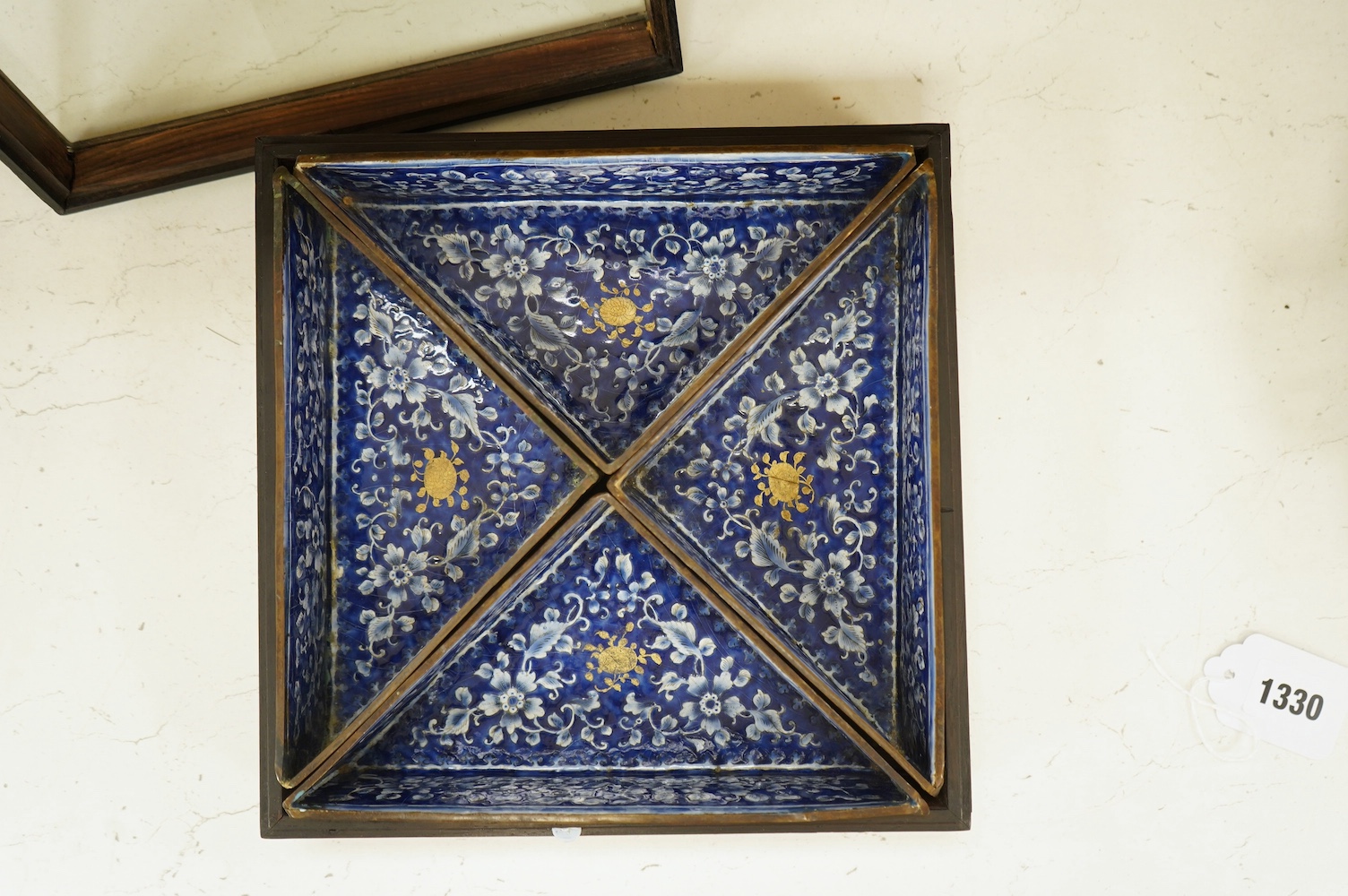 Four triangular 19th century Chinese Canton enamel sectional dishes, later boxed, 24cm wide overall. Condition - some restoration